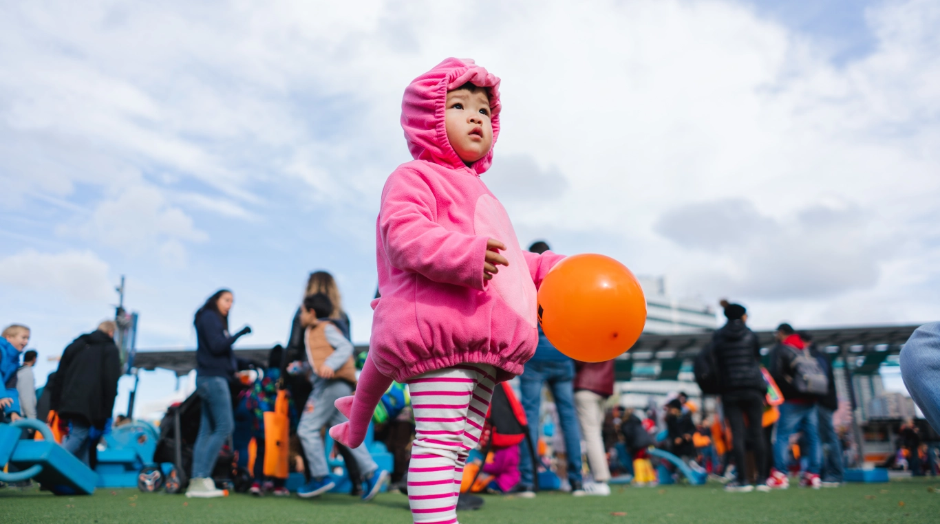 Photo of a small girl in a dinosaur hoodie